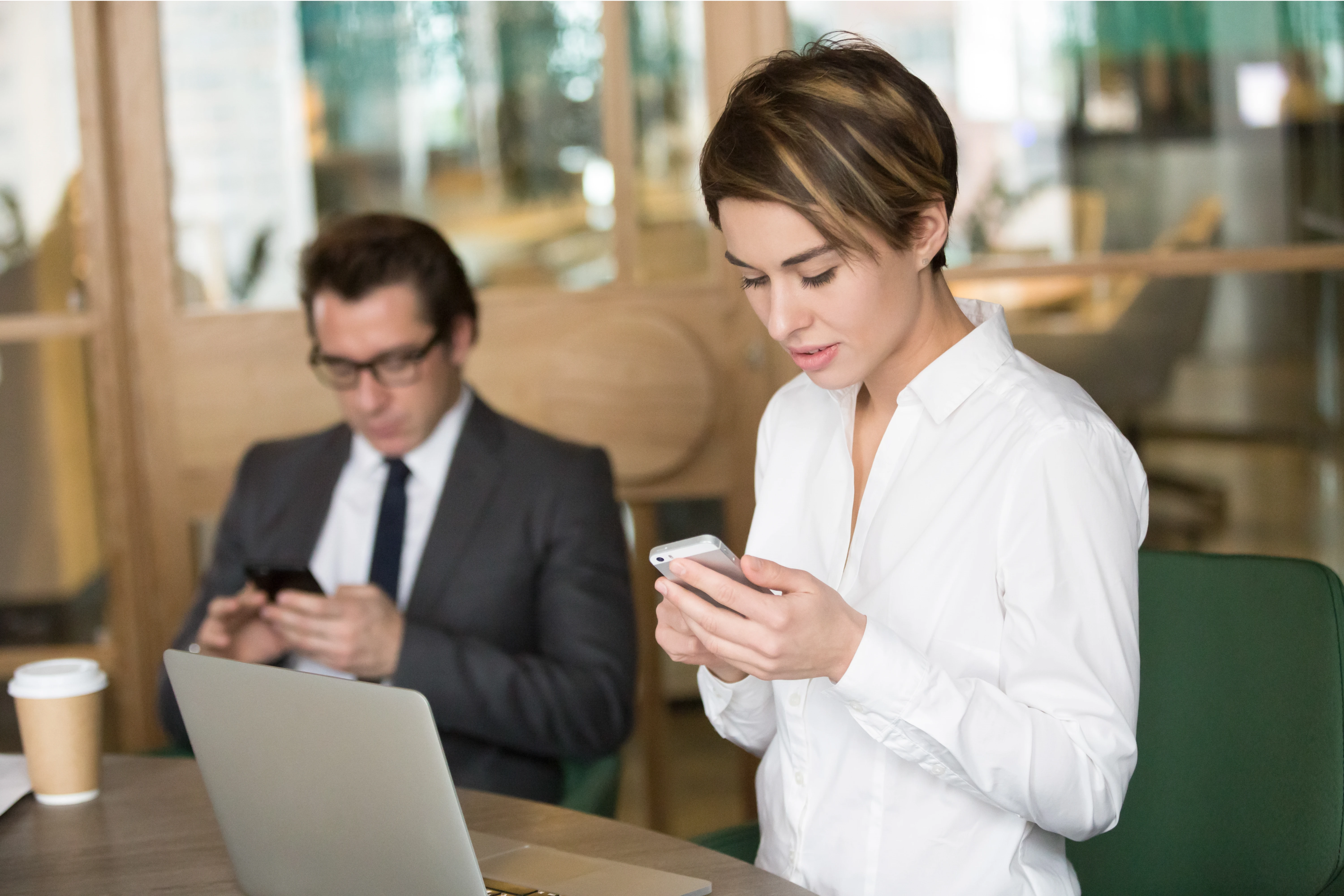 businesswoman_businessman_using_mobile_phones_work_office_1