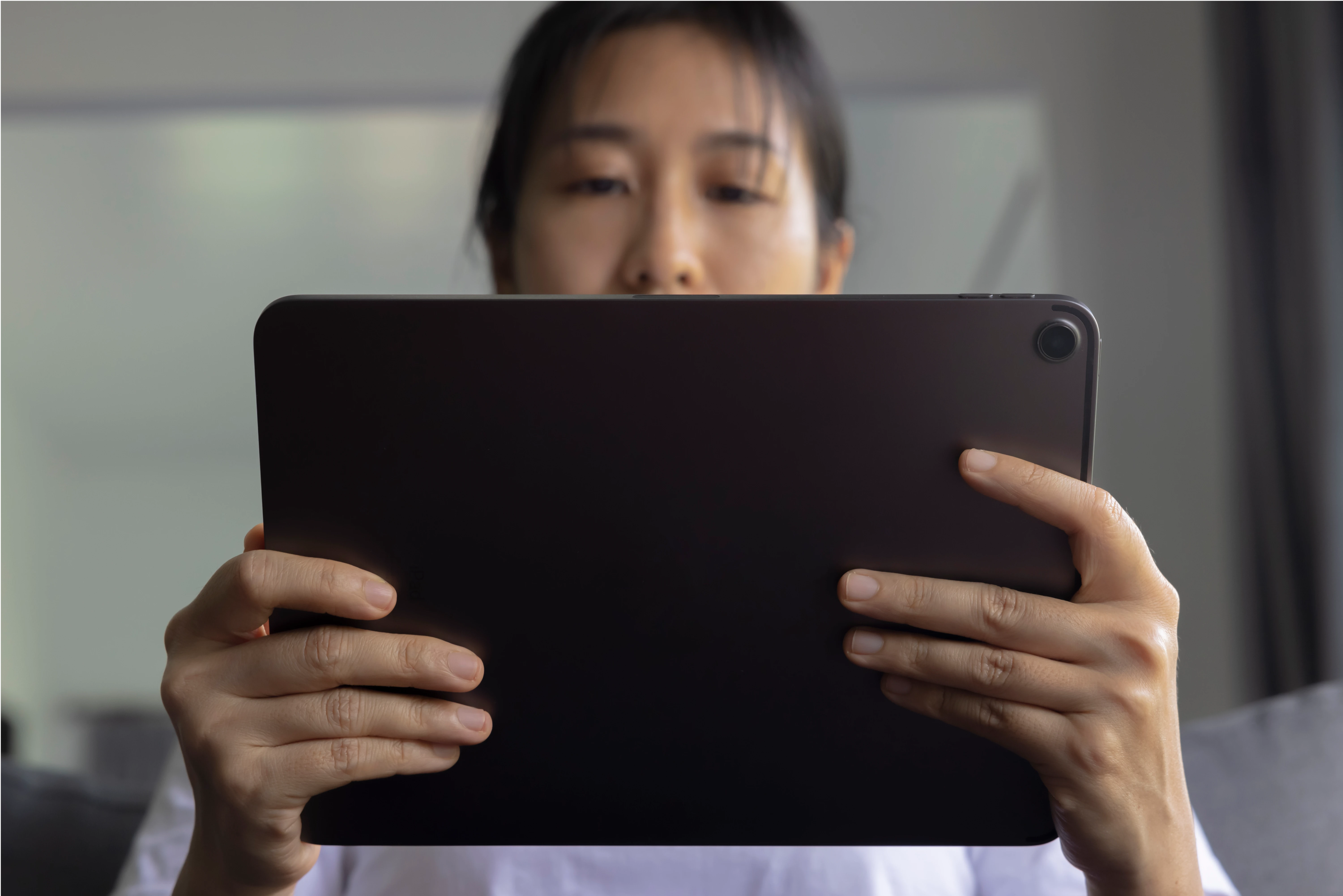 close_up_woman_hand_held_with_digital_tablet_sofa_living_room_concept_technology_connection_communication_1