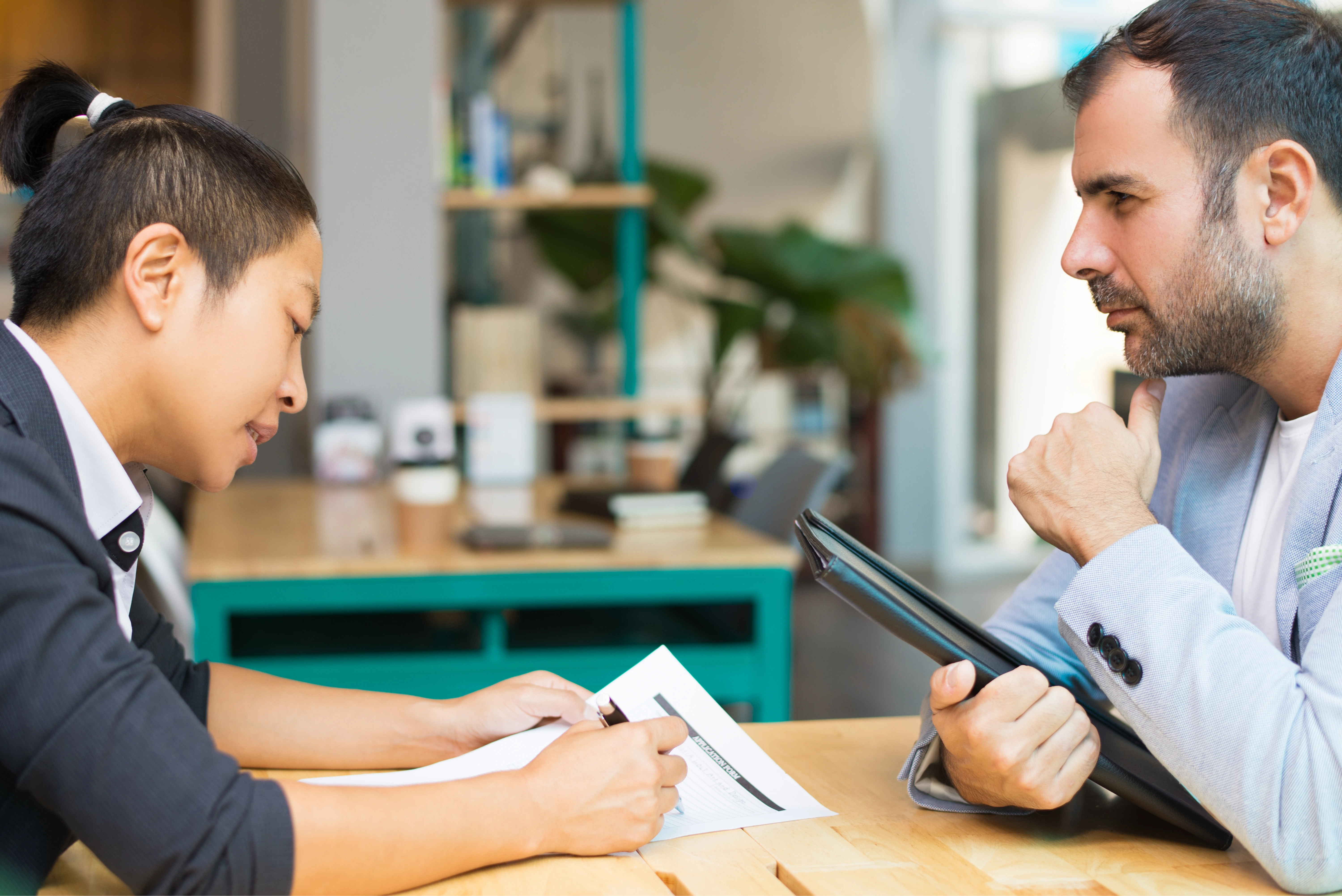 latin_asian_managers_sitting_working_with_documents_office_1
