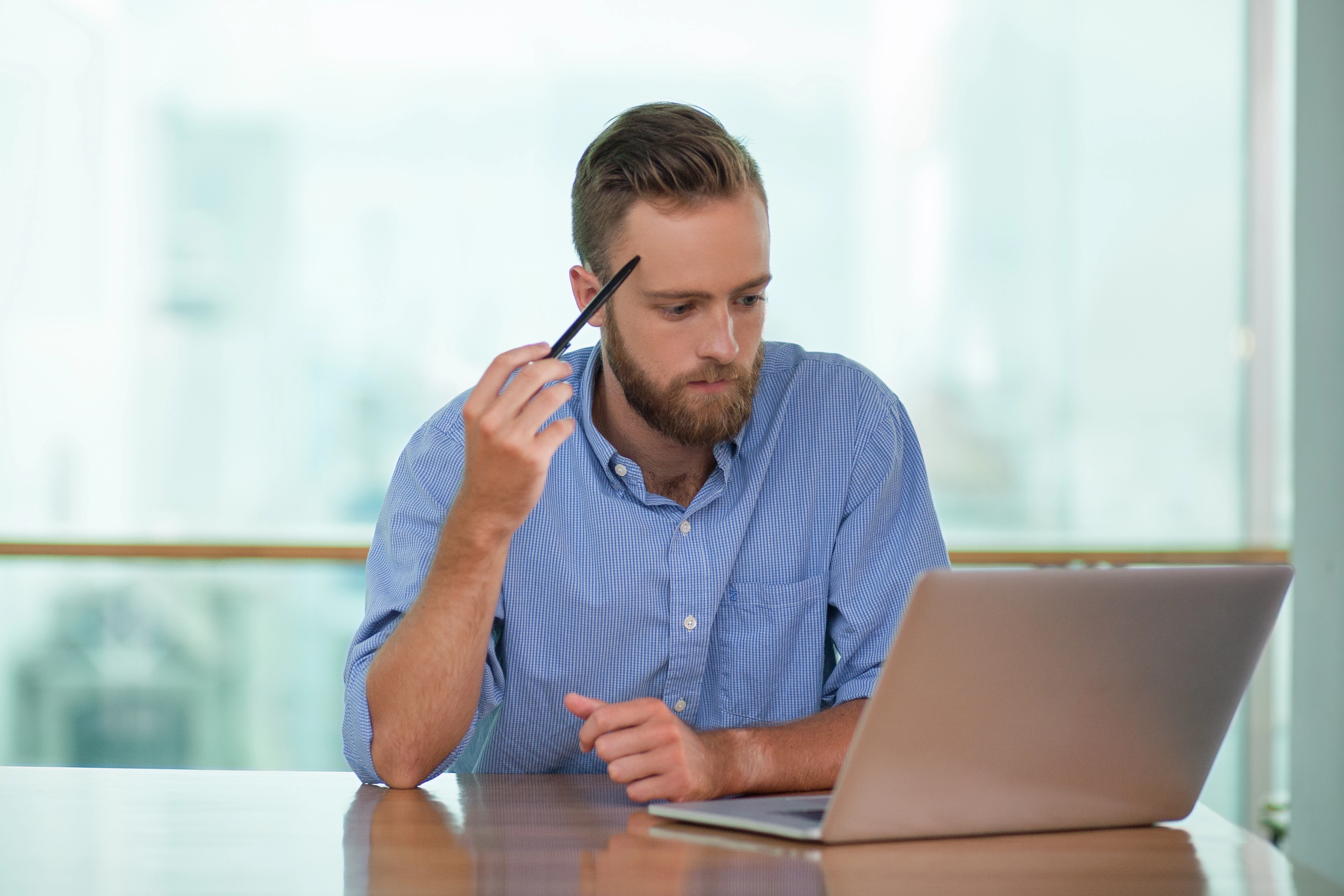 thoughtful_middle_aged_man_working_laptop_1