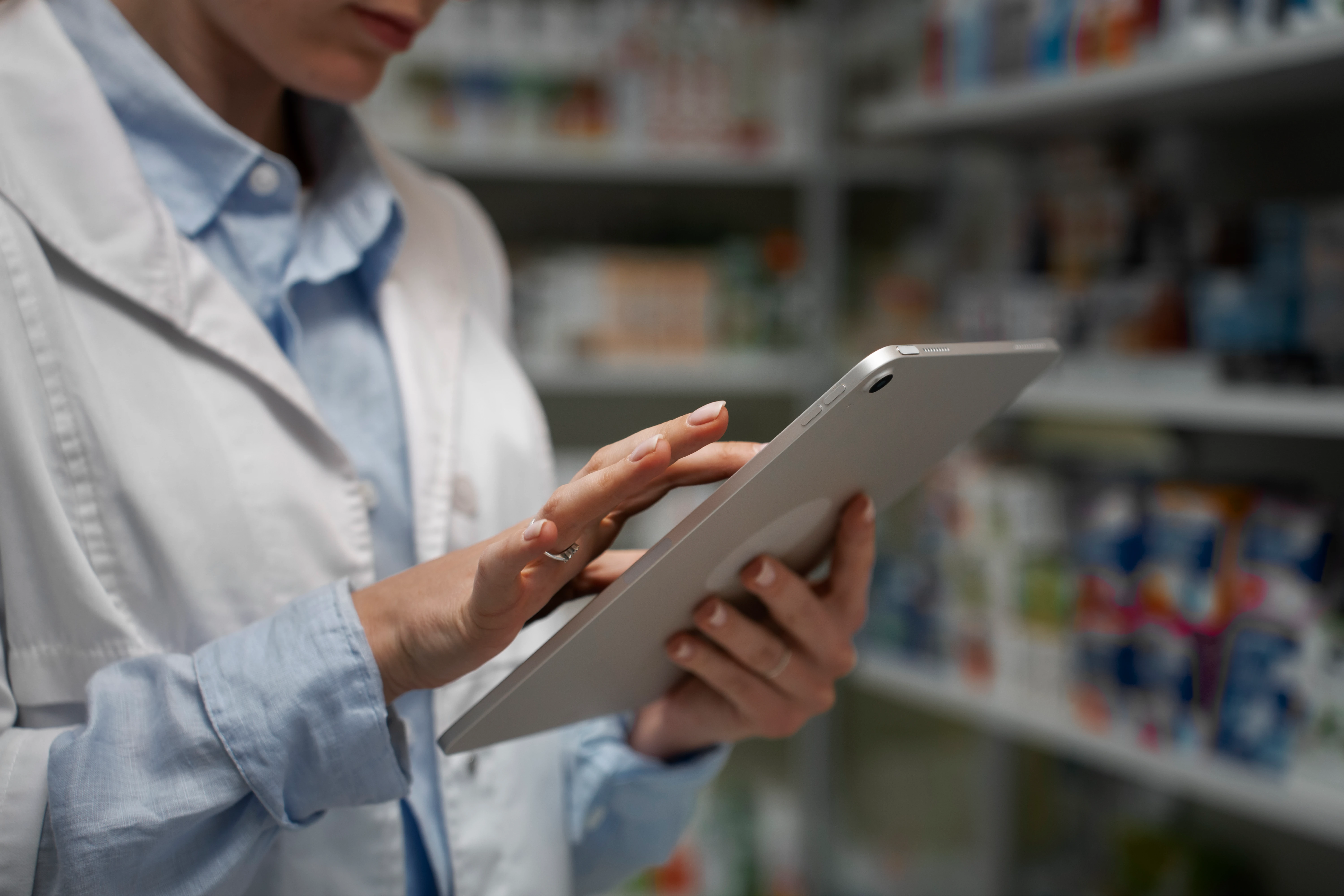female_pharmacist_with_table_checking_stock_pharmacy_1