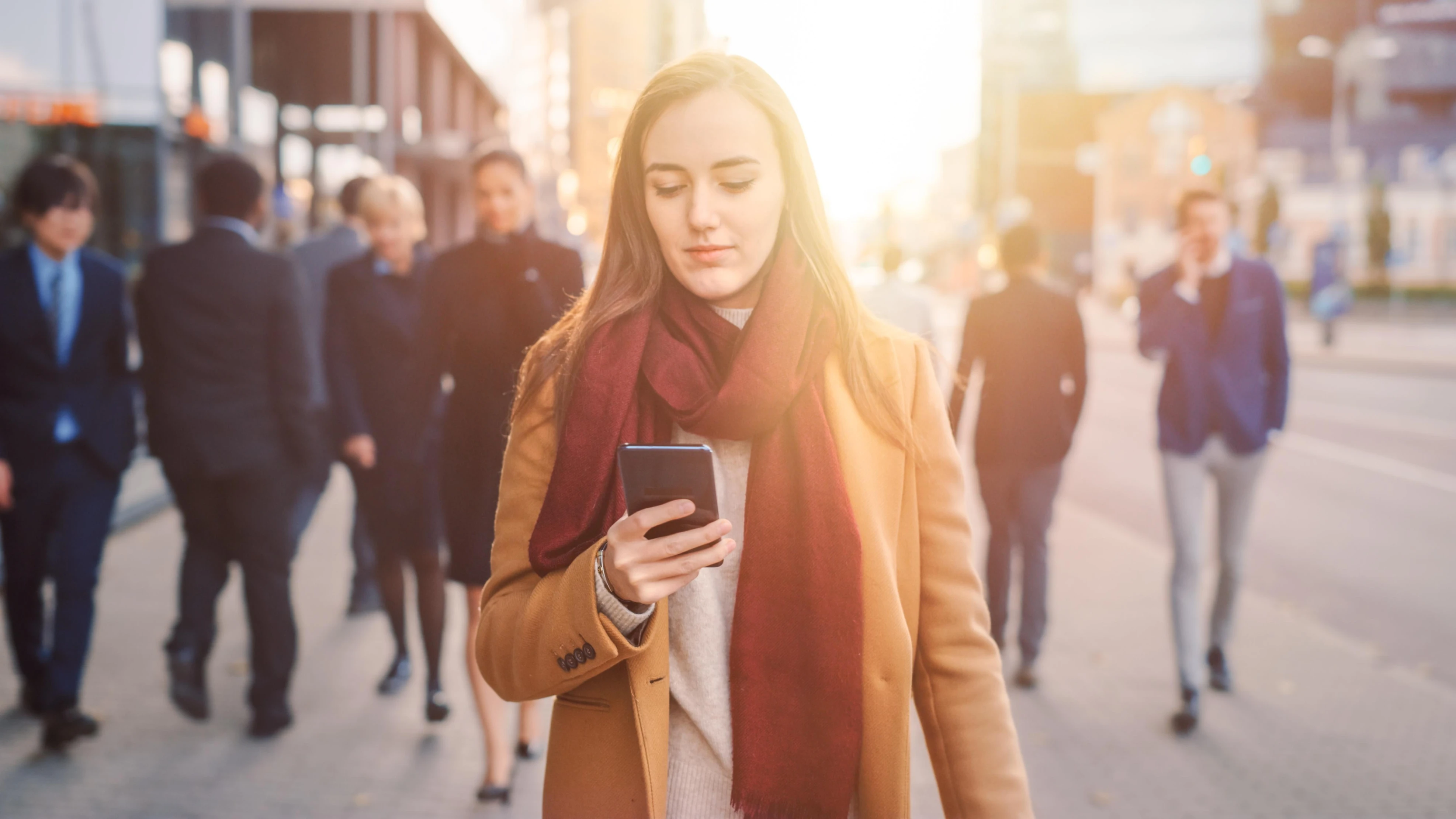 woman_walks_down_street_with_phone_her_hand_1